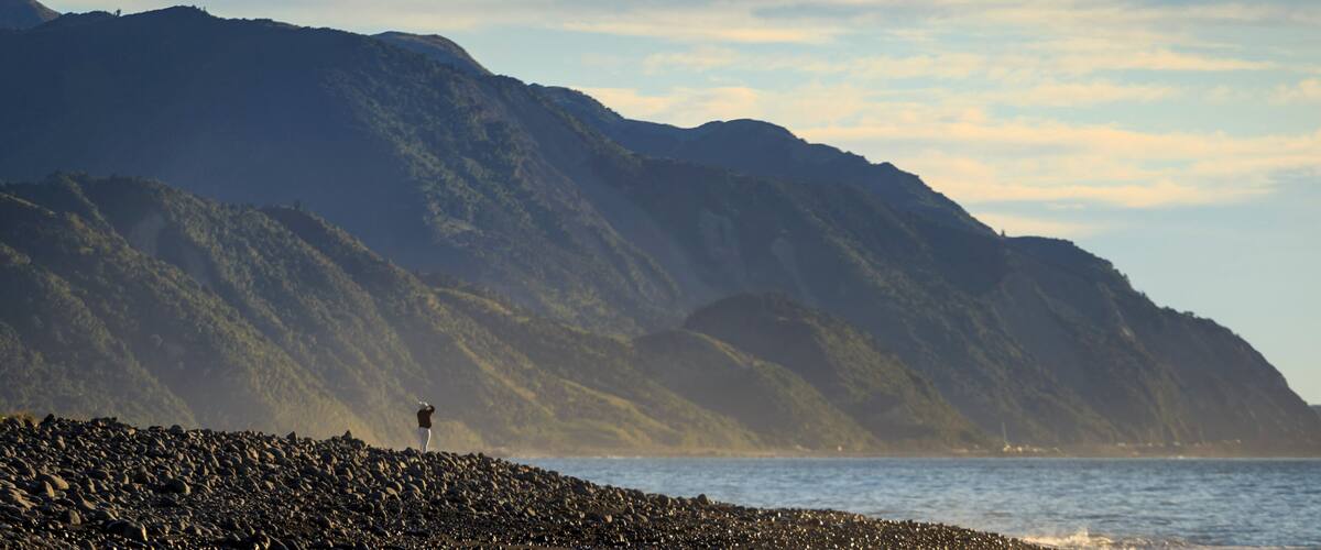 Person standing at lake with Kaikoura Seaward Range, Kaikoura South Island New Zealand