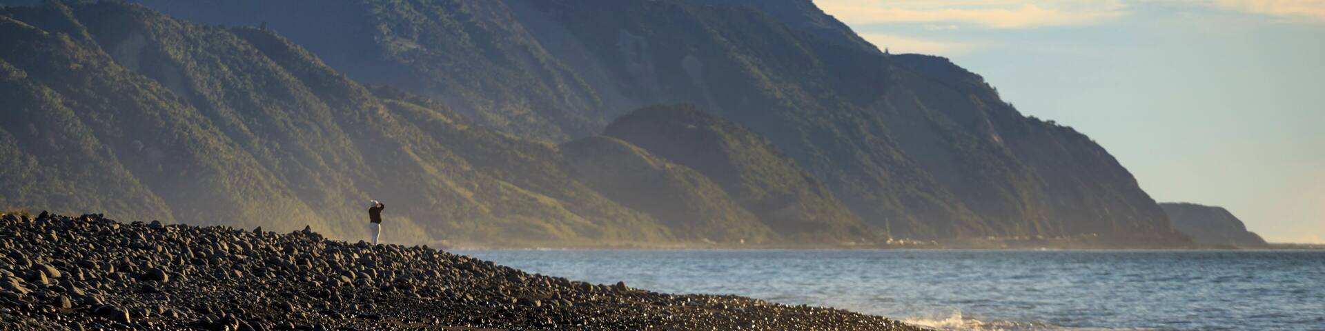 Person standing at lake with Kaikoura Seaward Range, Kaikoura South Island New Zealand