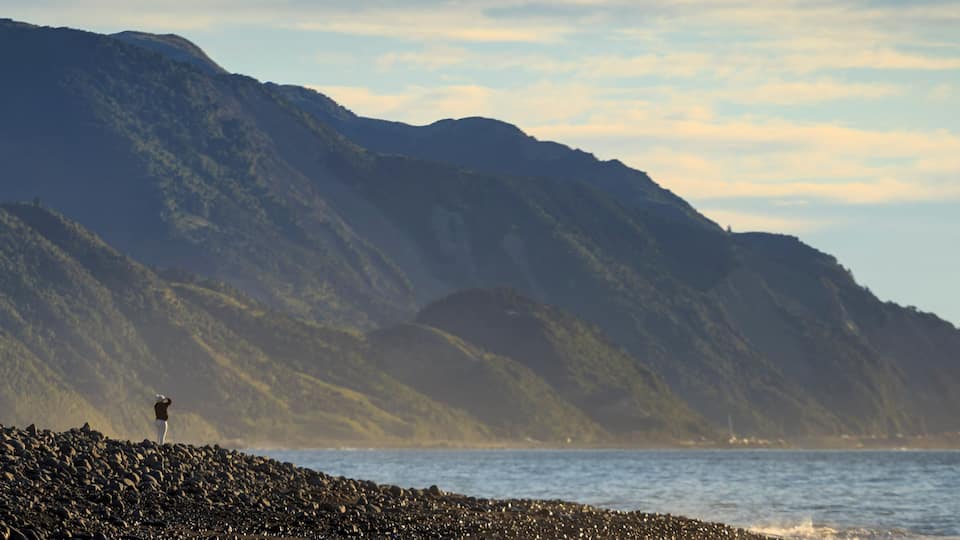 Person standing at lake with Kaikoura Seaward Range, Kaikoura South Island New Zealand
