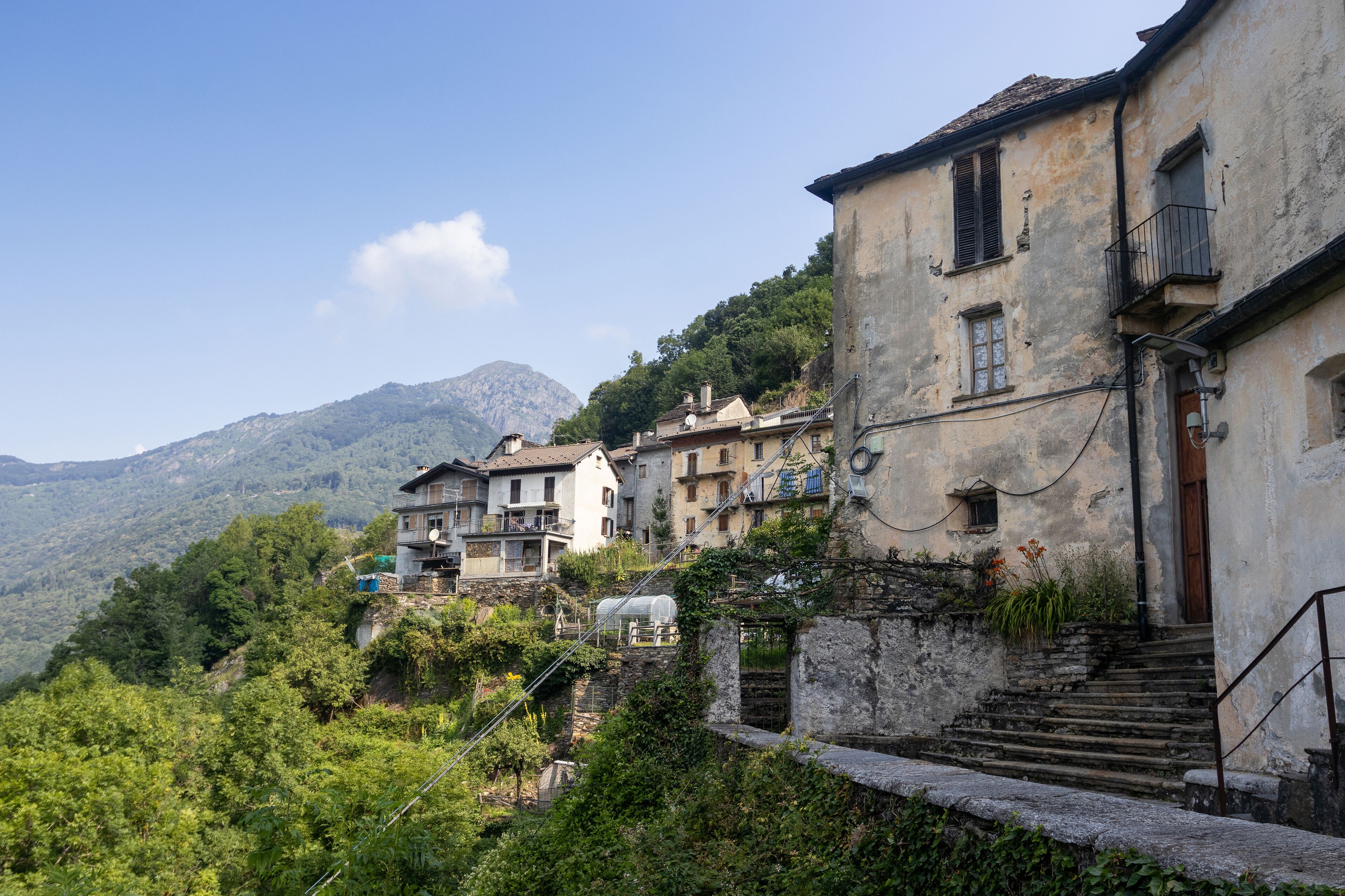 The quaint mountain village of Spoccia in the Cannobio Valley in Piedmont in Northern Italy. A car free historic village captured in the summer with clear sky and copy space above left.