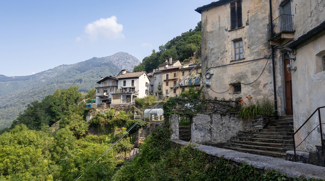 The quaint mountain village of Spoccia in the Cannobio Valley in Piedmont in Northern Italy. A car free historic village captured in the summer with clear sky and copy space above left.