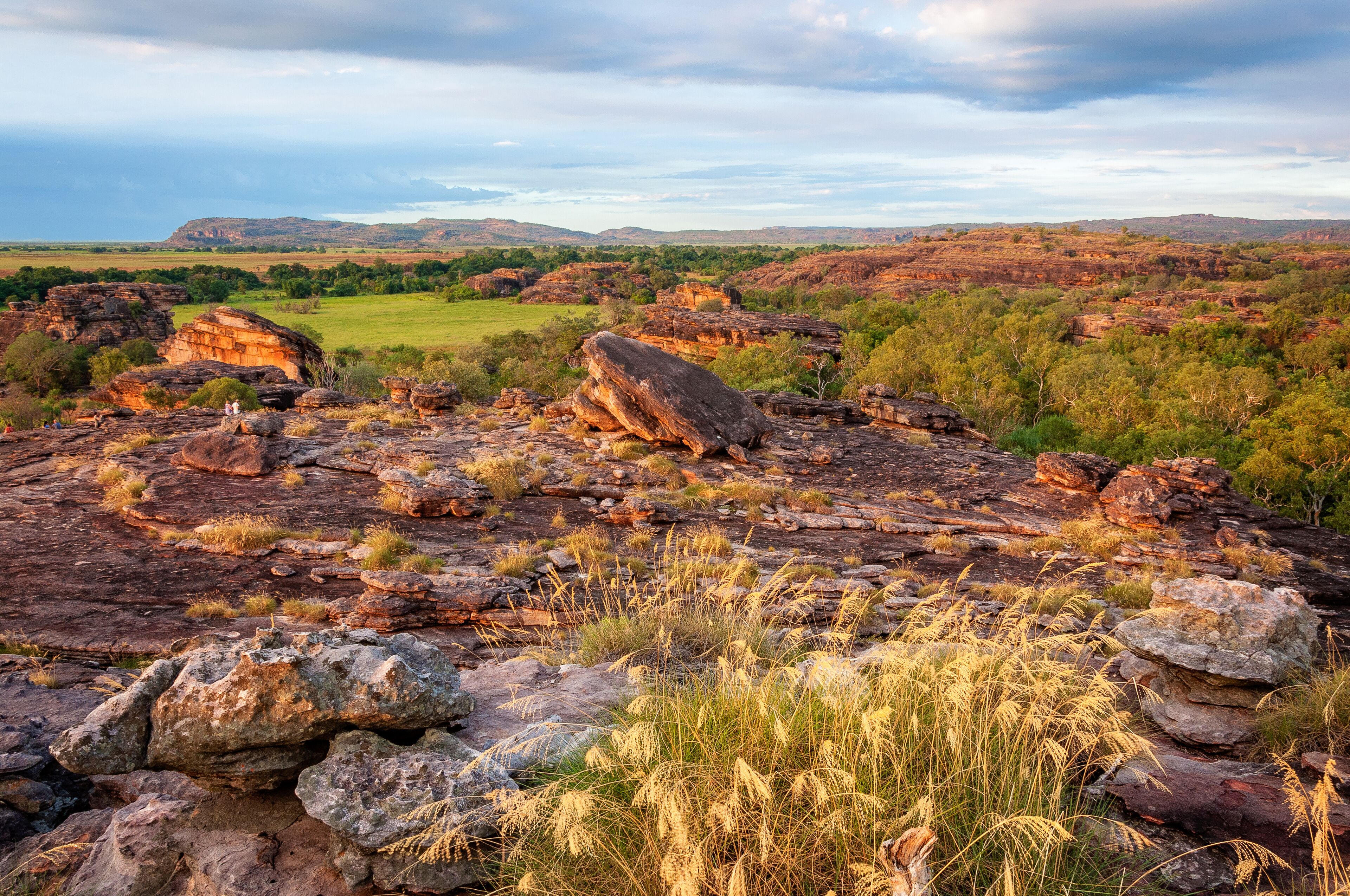 A rocky landscape with large boulders and sparse vegetation.