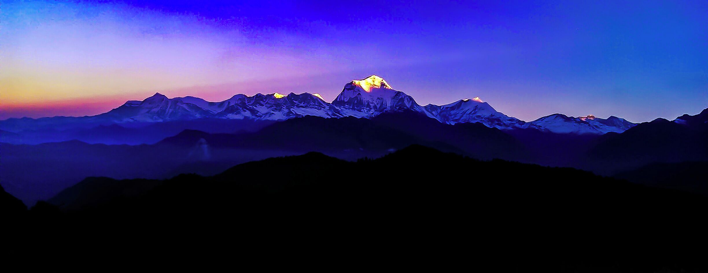 The first ray of the sun strikes the peak of the mighty Dhaulagiri of the Himalayas