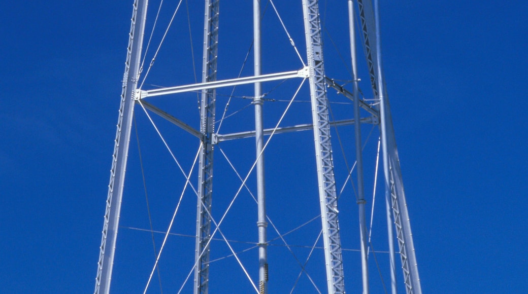 A water tower with the inscription 'DEER TRAIL' against a clear blue sky.