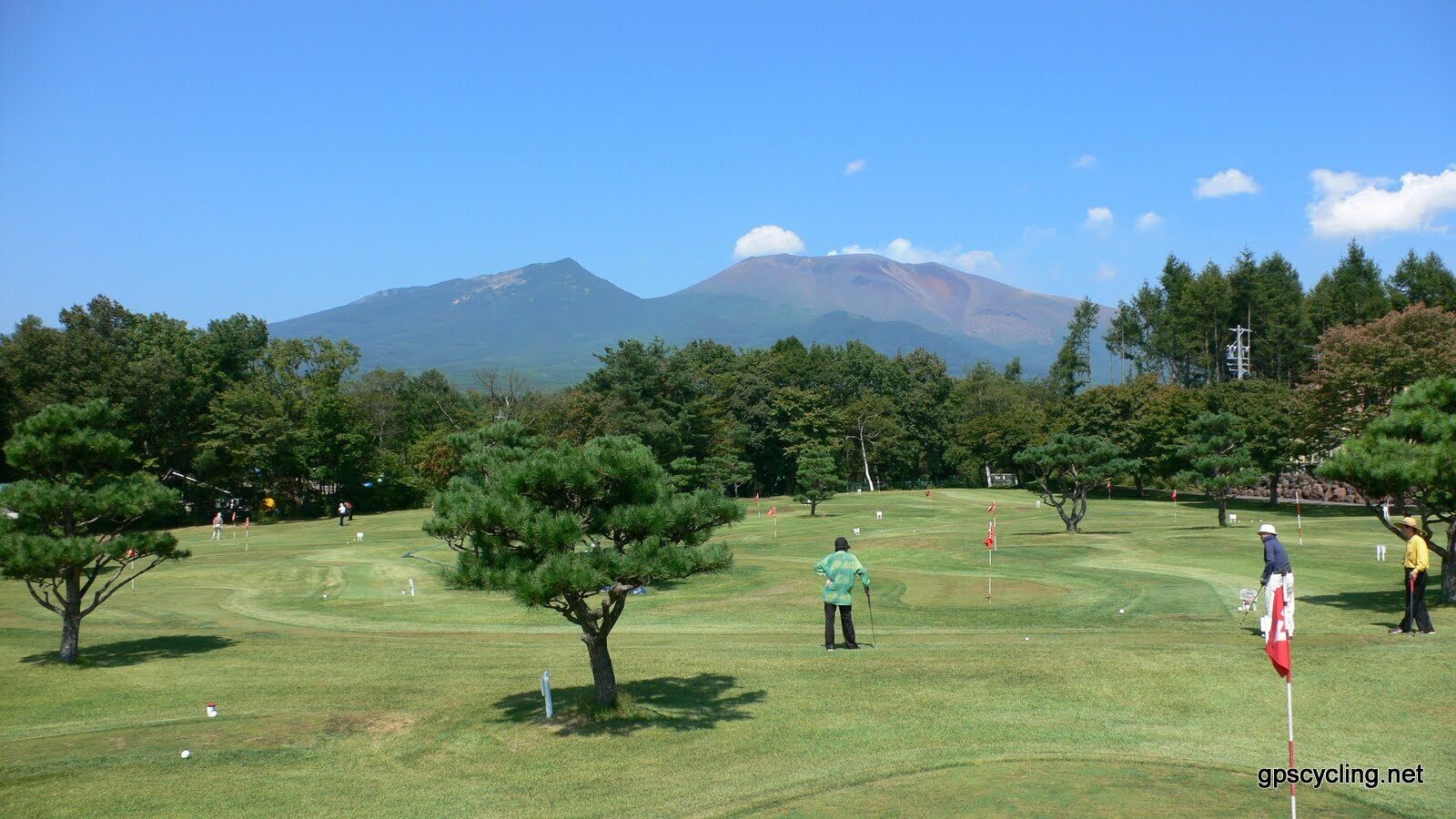 A golf course with a mountain in the background.