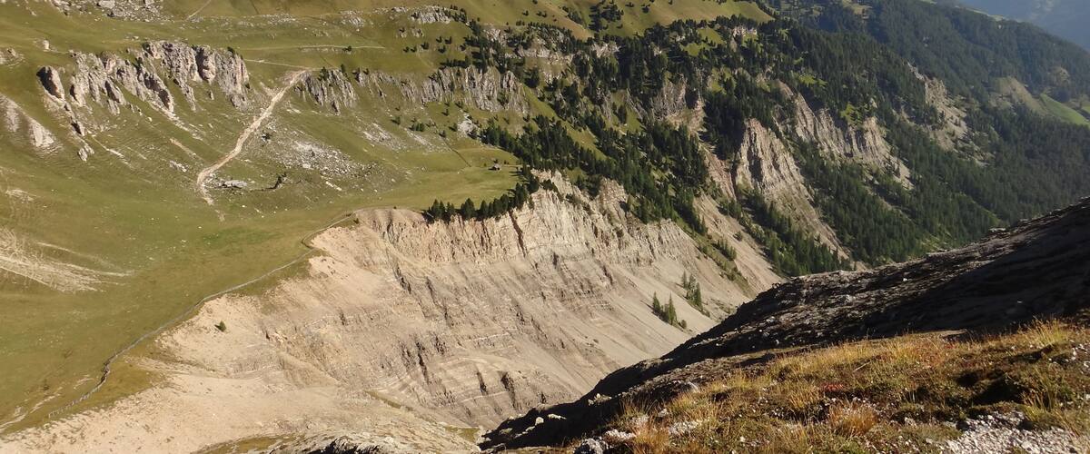 A mountain landscape with a prominent peak labeled "Sass de Putia."