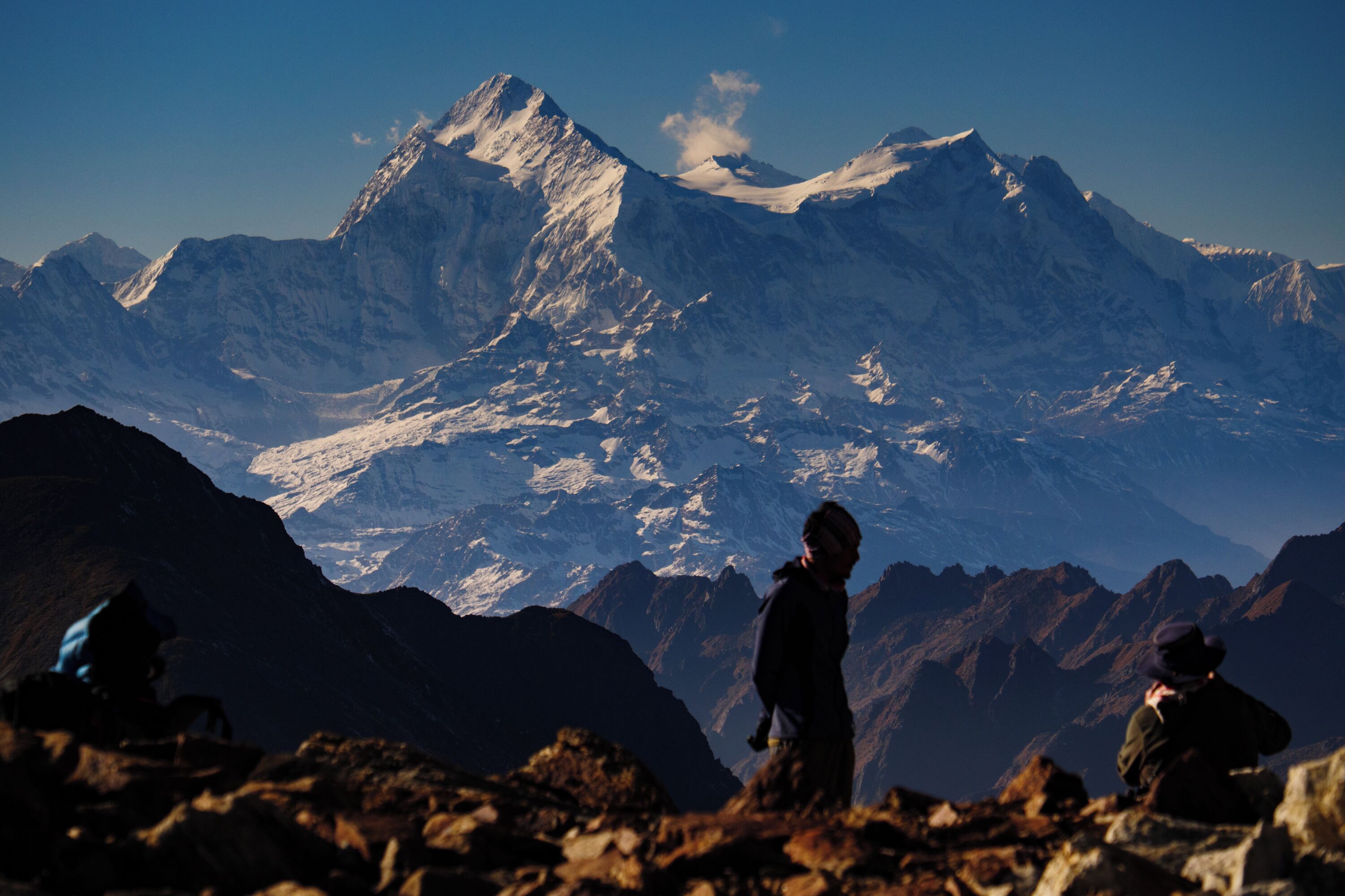 A mountainous landscape with a prominent peak and rocky terrain.