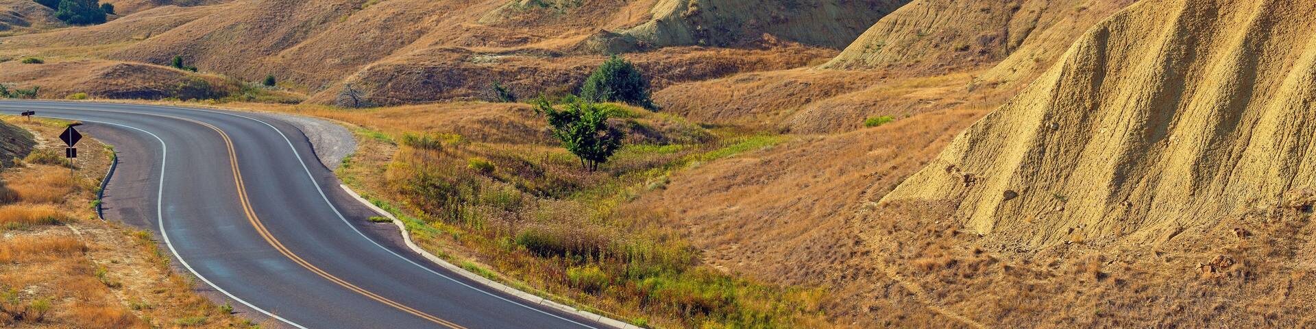 Yellow Mounds with highway in summer, Badlands national park, South Dakota, USA.