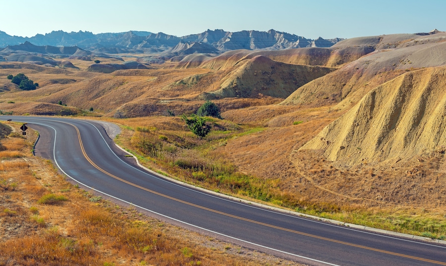 Yellow Mounds with highway in summer, Badlands national park, South Dakota, USA.
