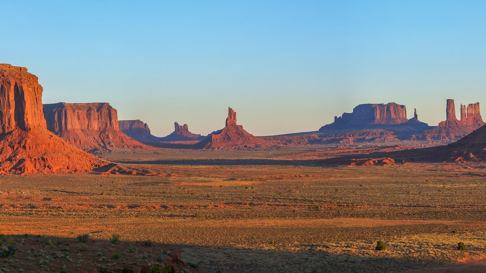 A desert landscape with prominent red rock formations.