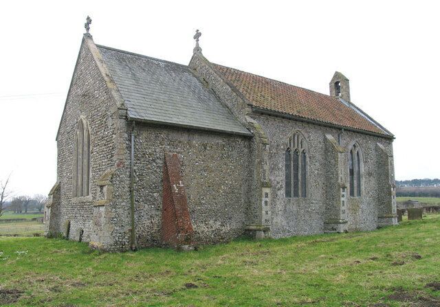 A stone church with a tiled roof and a bell tower.