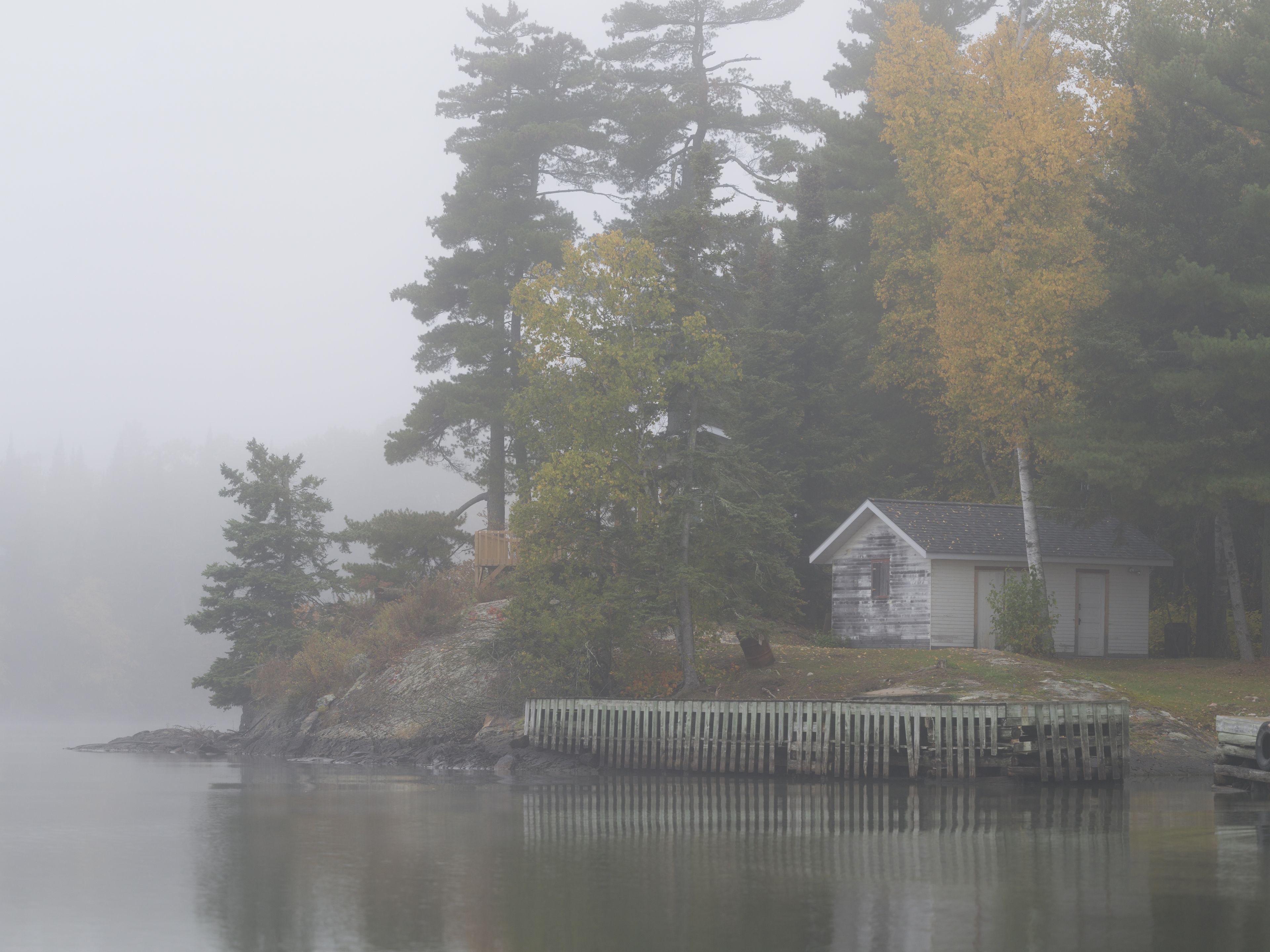 Beautiful view of a house in the Lake of the Woods on a foggy day