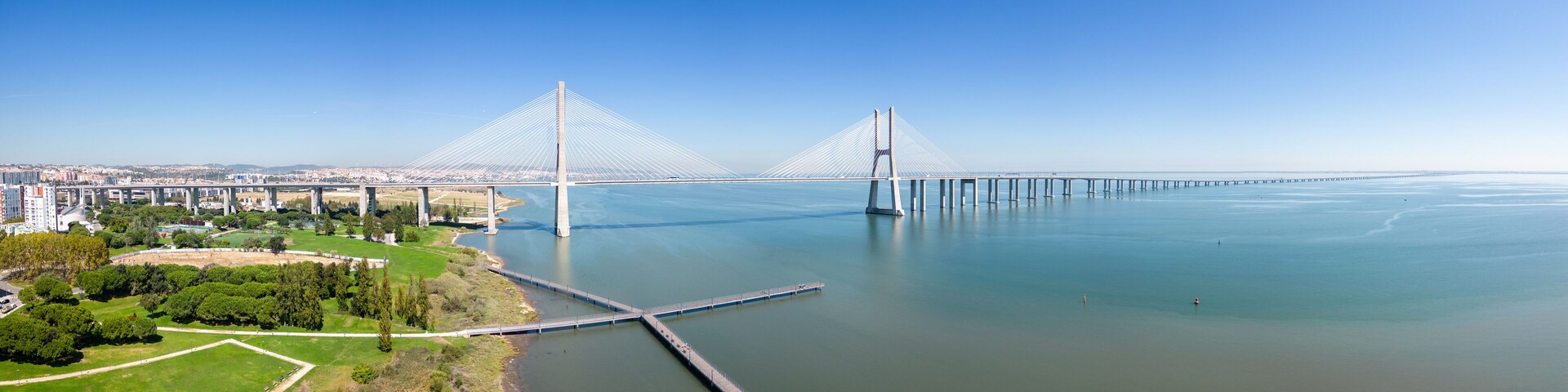 Aerial footage Vasco da Gama bridge at Park of The Nations in Lisbon (Parque das Nações)