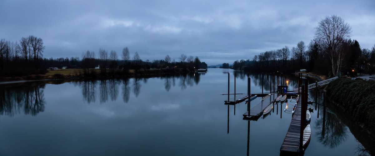 Beautiful view on Fraser River during a cloudy sunset. Taken in Fort Langley, Greater Vancouver, BC, Canada.