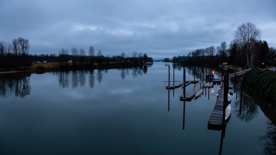 Beautiful view on Fraser River during a cloudy sunset. Taken in Fort Langley, Greater Vancouver, BC, Canada.