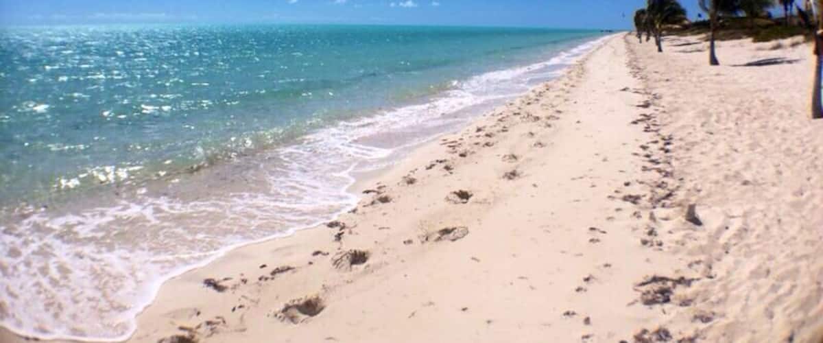 Long Bay Beach is a beautiful, secluded strip of white sand in  the south east part of Providenciales. Come here to watch kite surfers showcase their tricks. A heaven spot for pros and beginners who drift to this beach for the best wind, waters, and scenery in the world. #beach