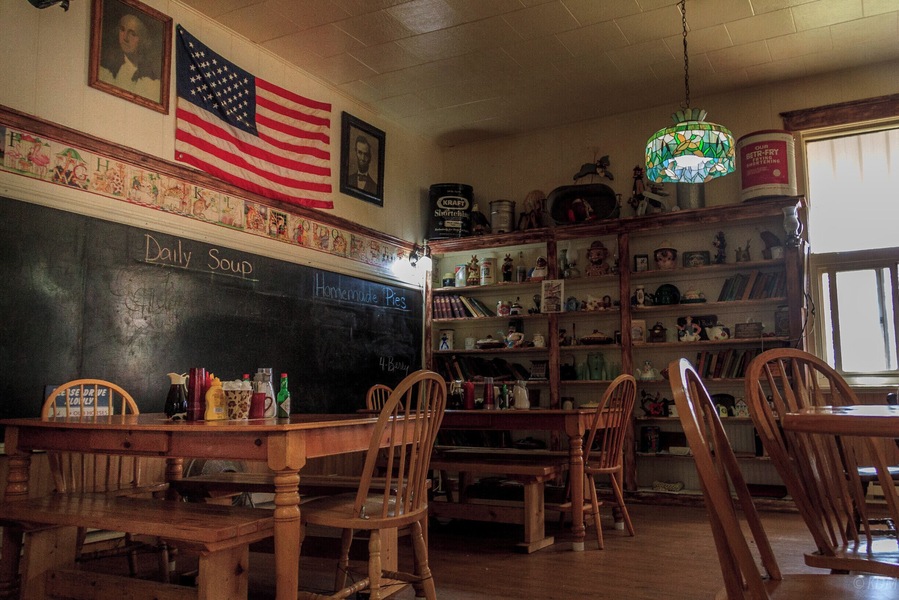 Yesterday's Cafe is located in a one-room brick school house complete with bell tower and bell. The building was constructed with locally made brick from the red butte directly behind the school. Built in 1903 and filled with school children until 1963 when the school consolidated with Lima, 8 miles to the south. The interior and exterior of the school are much the same as it was 80 years ago. The maps, chalk boards, hardwood floors and school books still fill the building. Our menu features homemade pies, soups, roll and hamburger buns, daily lunch and dinner specials. Come step back in time and enjoy a home cooked meal with us.
Saloon and casino with beer and wine available. The Saloon is filled with antiques and original iron work. Meals from the cafe can be served in the saloon. We also have a gift shop with handmade quilts and many one of a kind items. Nearly all of which are made in Montana.
Directions: Yesterdays Cafe is located at Exit 23 off Interstate I-15 in southwest Montana in Dell Montana. 40 miles south of Dillon, Montana.