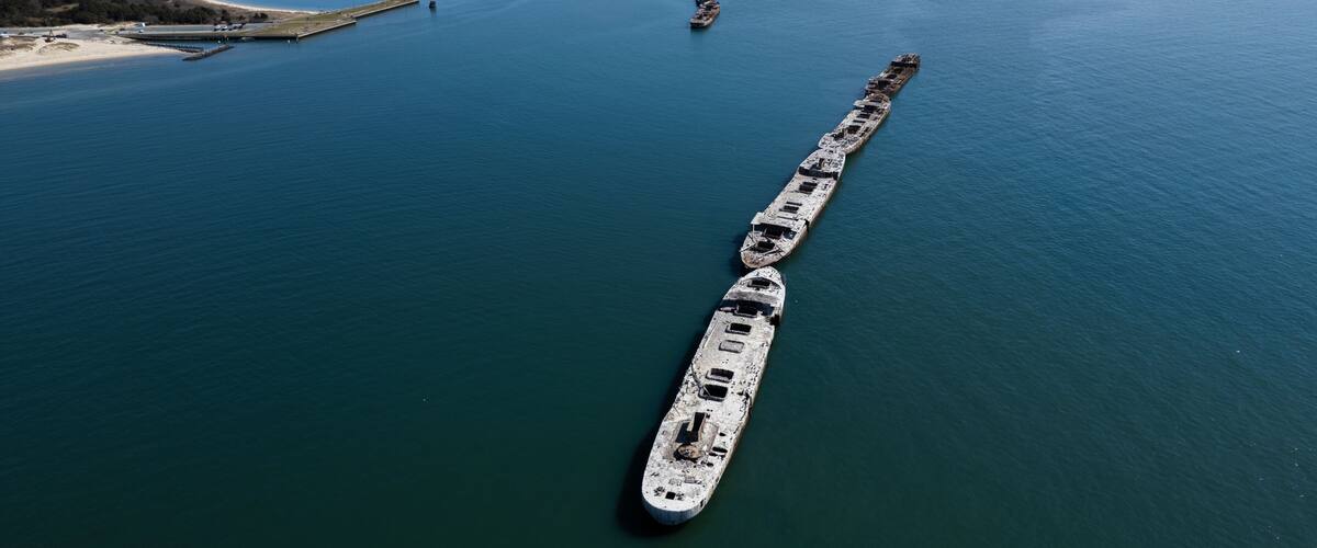 An aerial shot of abandoned concrete ships from World War II