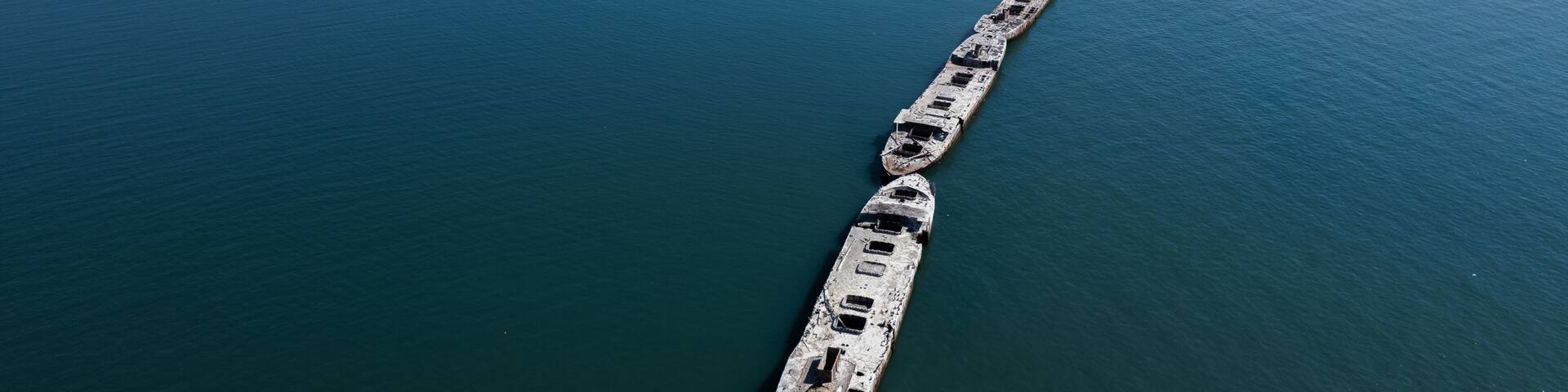 An aerial shot of abandoned concrete ships from World War II