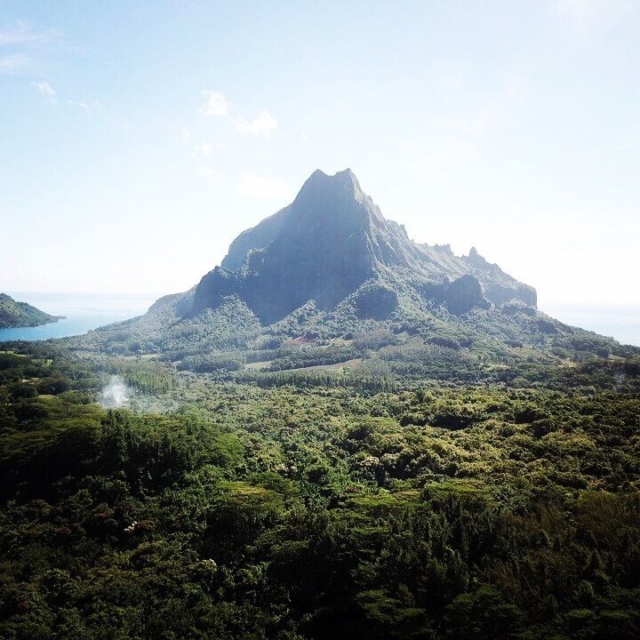 A mountain with a lake in the foreground and a clear sky.