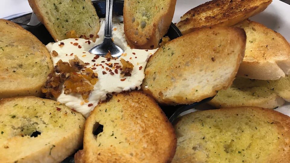 Baked goat cheese with dried apricots, walnuts, and garlic bread #Yum