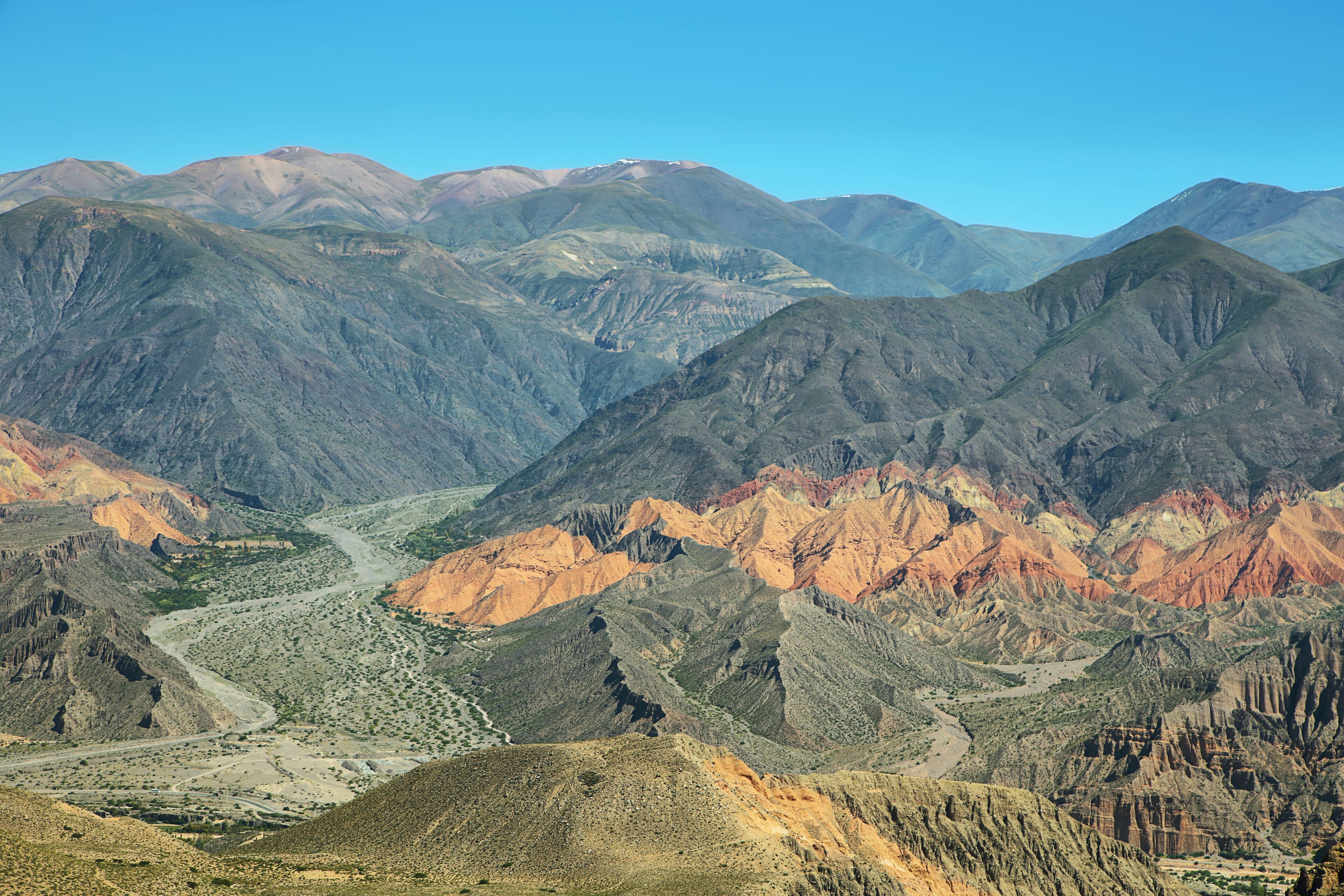 A rugged mountain range with a winding river.