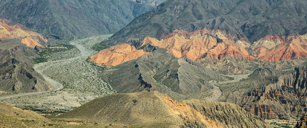 A rugged mountain range with a winding river.