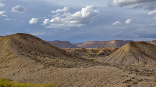 white clouds over Christmas Ridge and deserted hills near Crescent Junction, Grand County, Utah