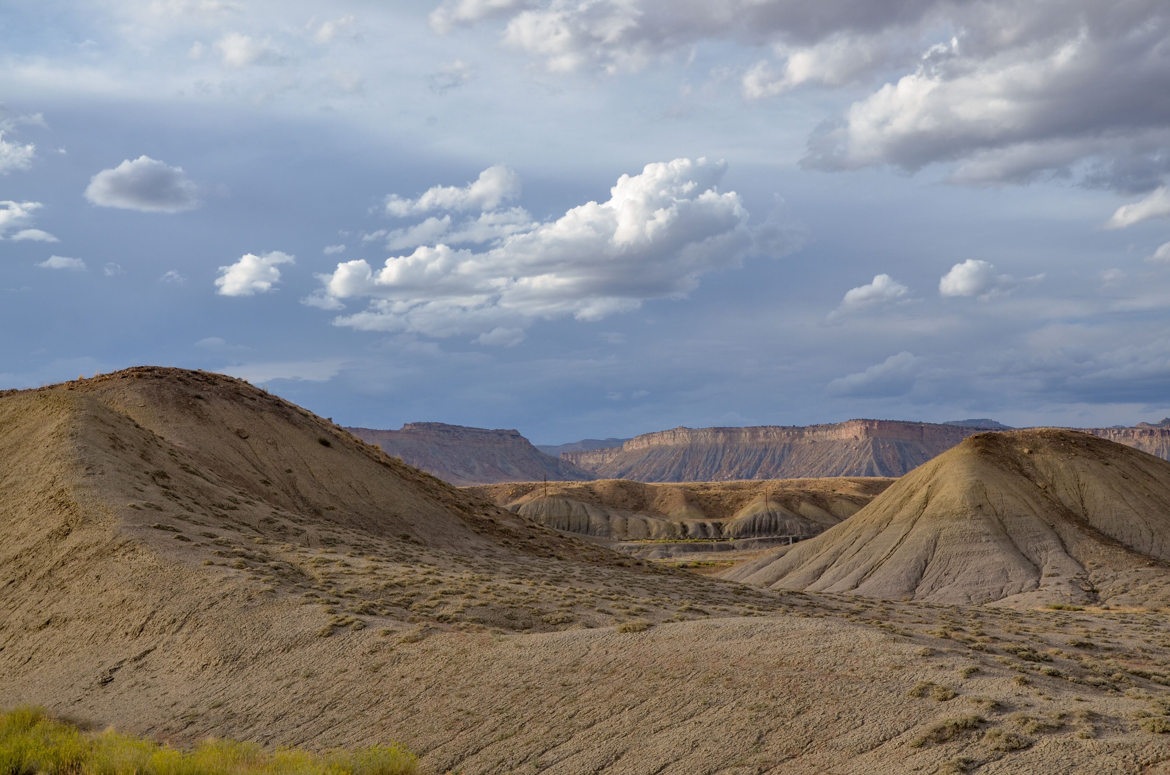 A desert landscape with rolling hills and a clear sky.