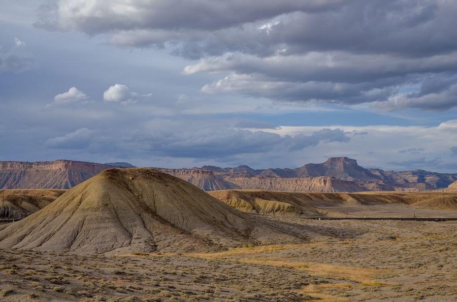 white clouds over Christmas Ridge and deserted hills near Crescent Junction, Grand County, Utah