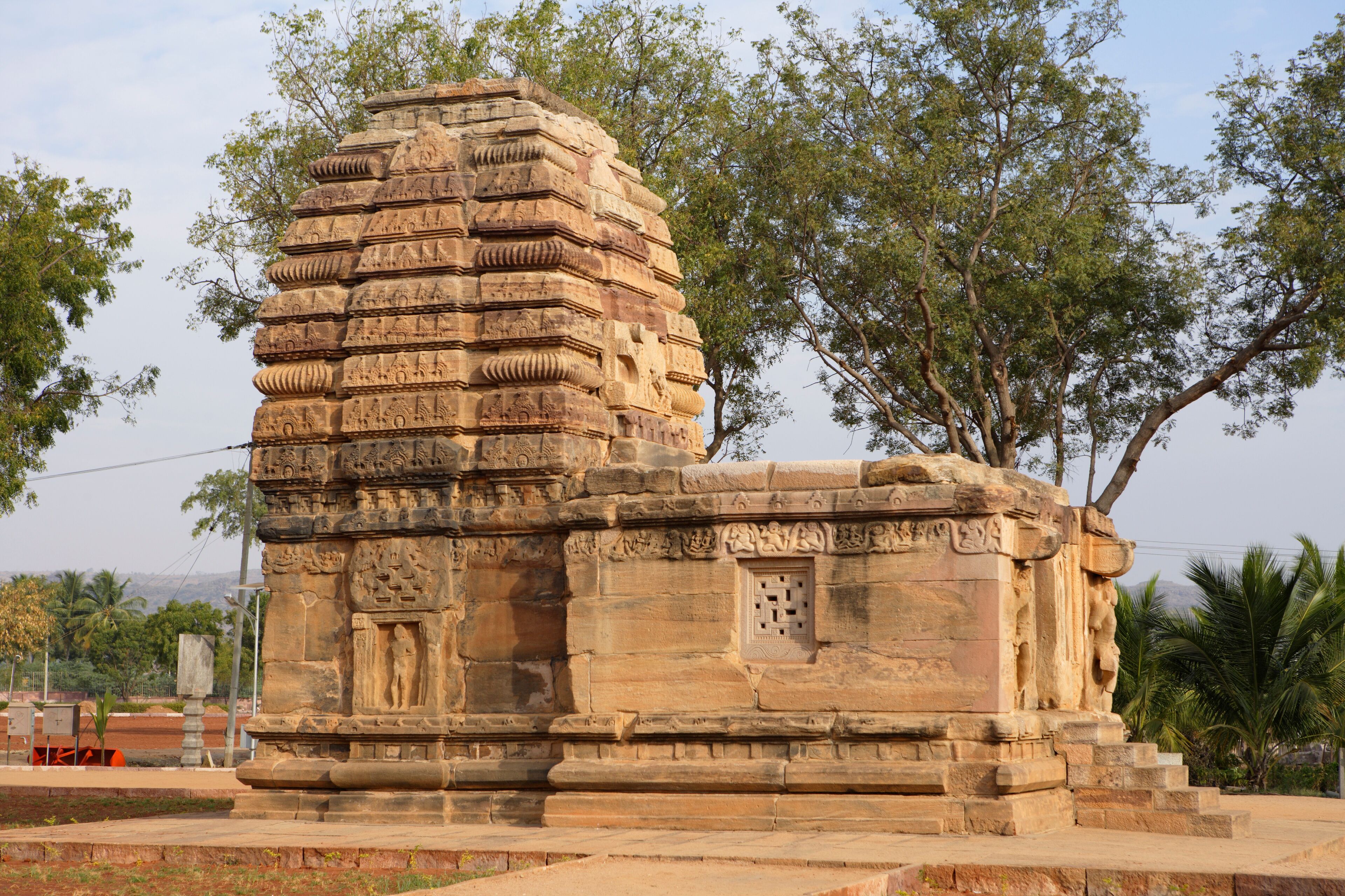 A stone temple with intricate carvings and a stepped structure.