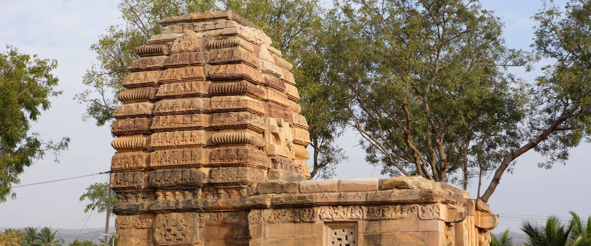 A stone temple with intricate carvings and a stepped structure.