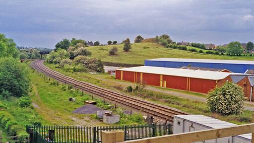 Site of Gresley station, 1995. View westward, towards Burton-on-Trent: ex-Midland Leicester - Burton line. The station, - mainly located off to the right, was closed 7/9/64 when the Leicester - Burton passenger service ceased. However, the line has remained open for freight and may yet have a passenger service on the 'Ivanhoe Line'.