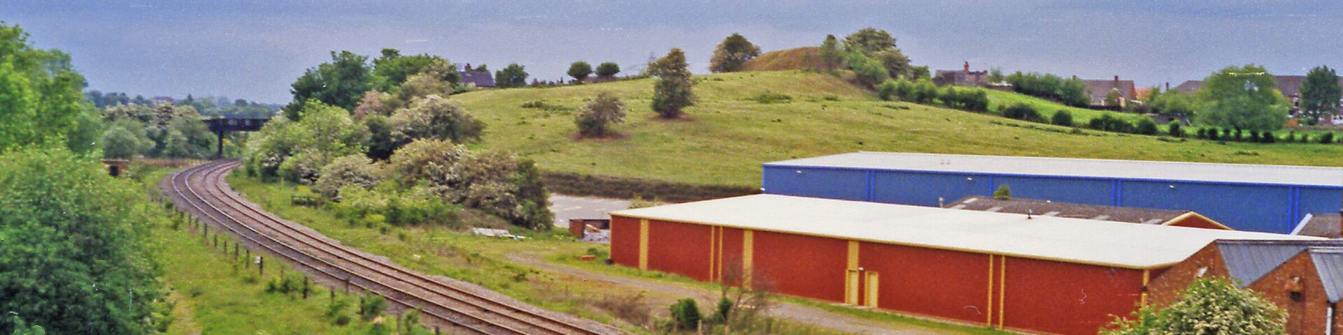 Site of Gresley station, 1995. View westward, towards Burton-on-Trent: ex-Midland Leicester - Burton line. The station, - mainly located off to the right, was closed 7/9/64 when the Leicester - Burton passenger service ceased. However, the line has remained open for freight and may yet have a passenger service on the 'Ivanhoe Line'.