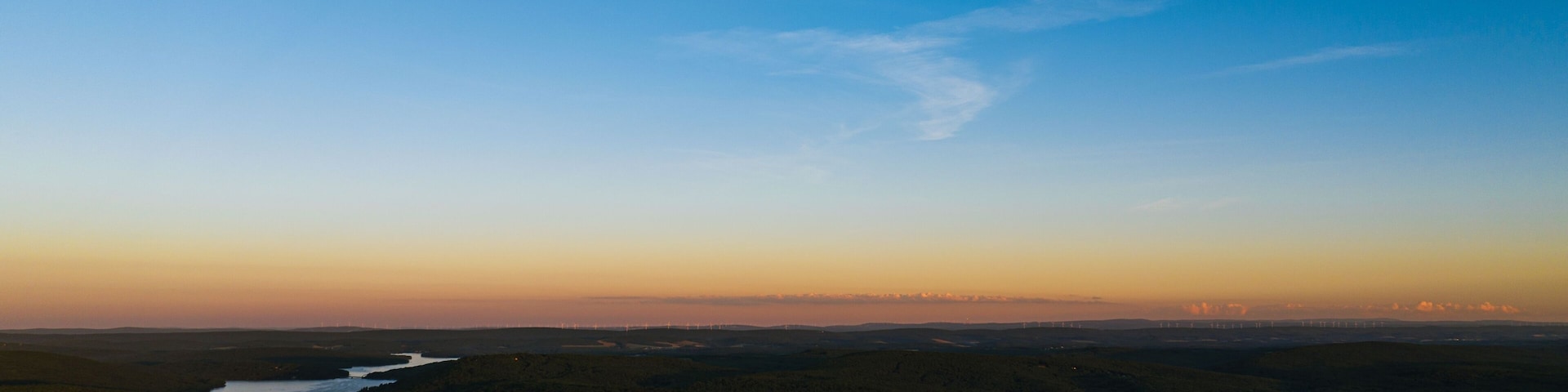 Beautiful landscape with the Deep Creek Lake under a sunset sky