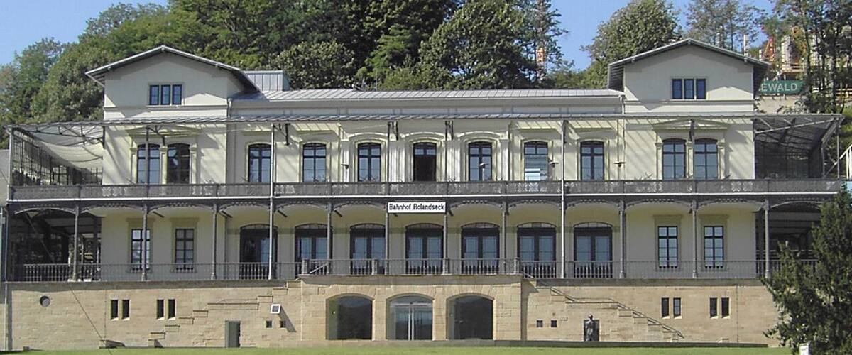 A large, historic building with a symmetrical facade, multiple windows, and a central entrance.