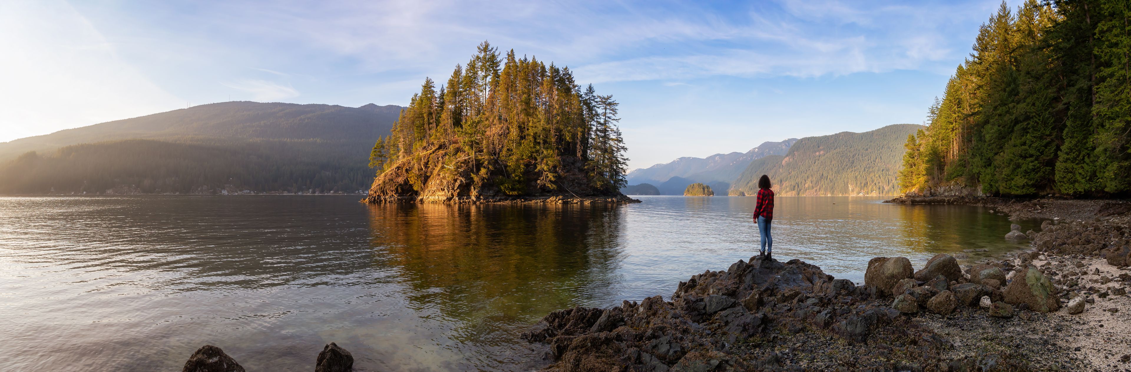Girl Hiking in the Canadian Landscape during a vibrant winter sunset. Hike on Jug Island Trail in Belcarra, Vancouver, British Columbia, Canada. Nature Panorama Background