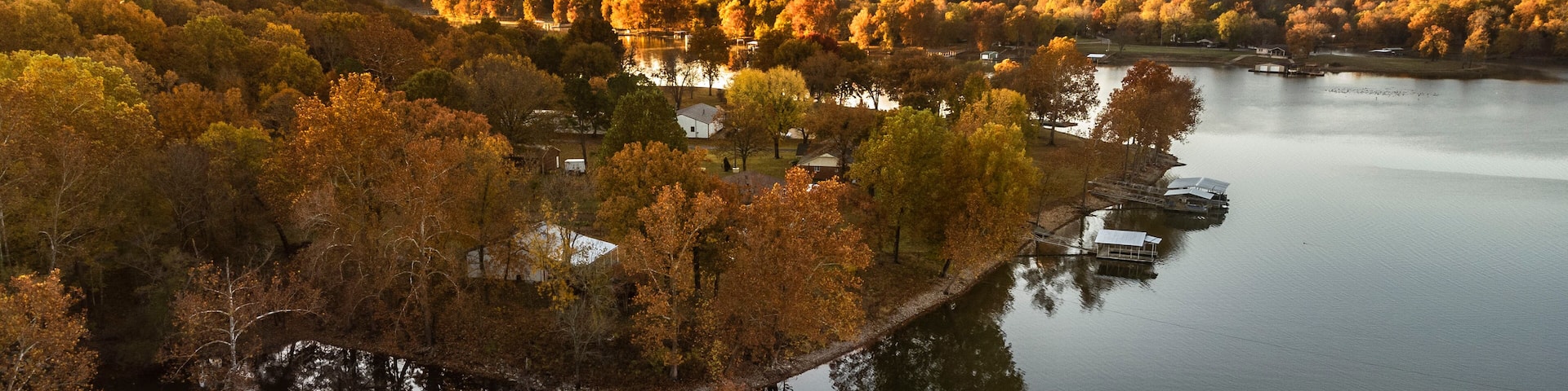 Fisherman fishing during fall sunrise on grand lake in oklahoma