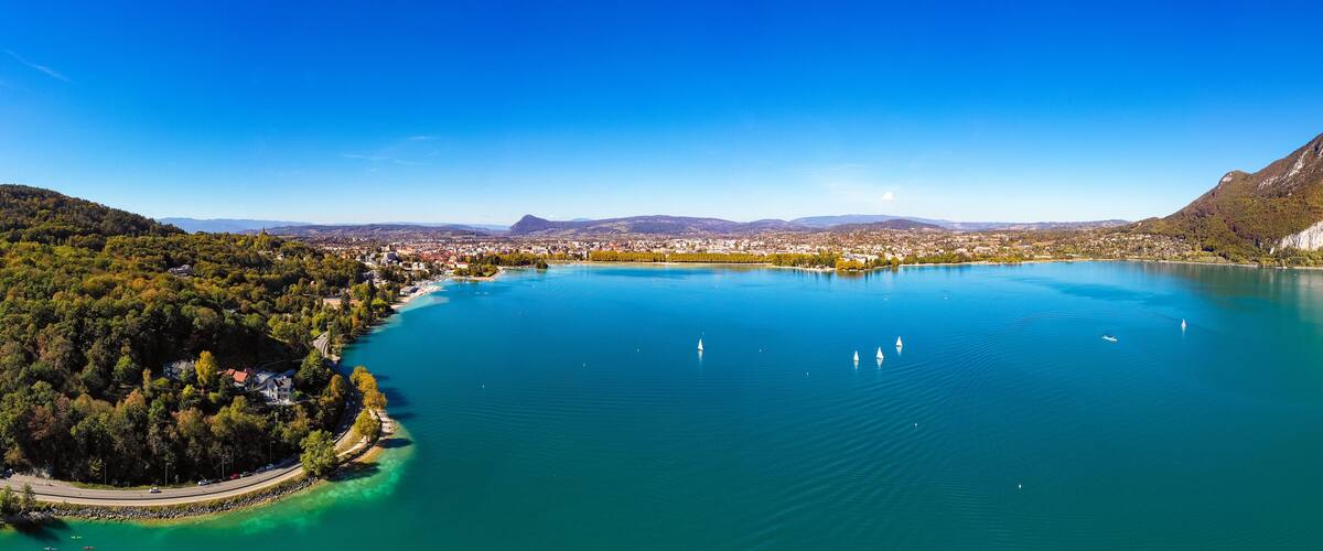 A lake surrounded by mountains and a town.
