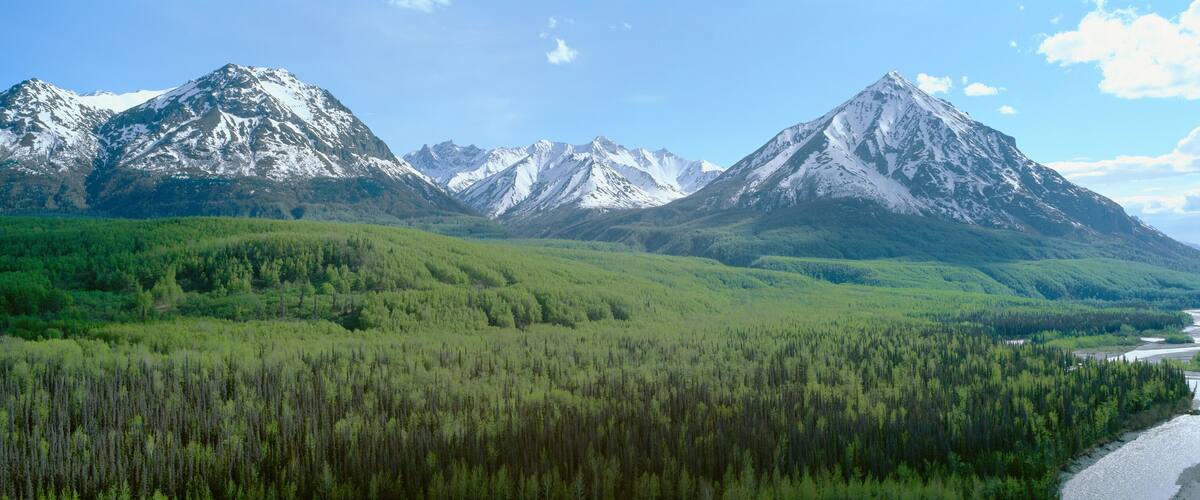 Snowy mountains, green forests and river in Matanuska Valley, Alaska