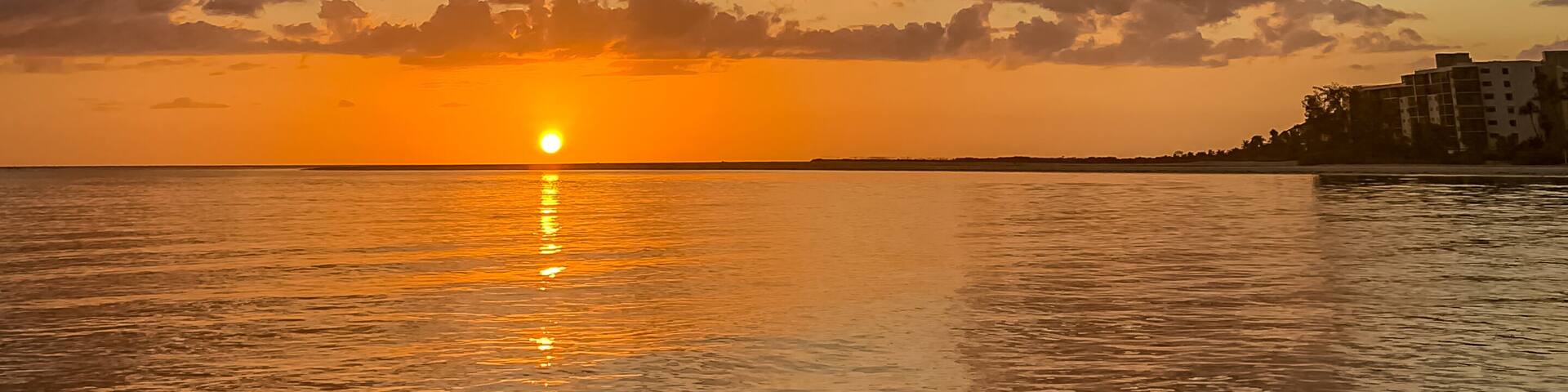 Portrait view of dramatic sunset over Fort Myers seen from Estero Bay