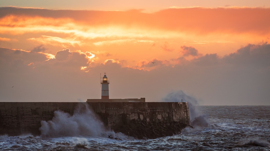 Strong December winds and tide at Newhaven lighthouse west beach on the east Sussex coast south east England UK