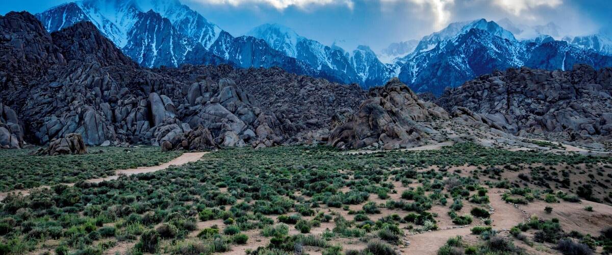 A mountainous landscape with rocky terrain and sparse vegetation.