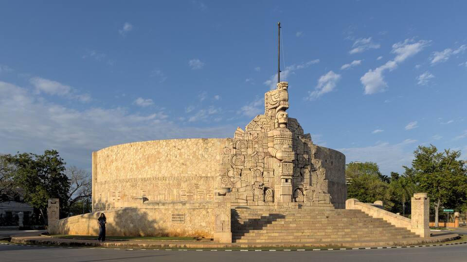 A large stone monument with intricate carvings and a tall spire.