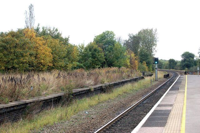 Olton railway station photo-survey (12) Looking in the down (northbound) direction at Olton station. Note the overgrown disused platform to the left of the photo (see below). Olton station is on the ex-GWR (Great western Railway) London to Birmingham line. It serves the suburbs of Olton and Ulverley Green about six miles east-southeast of Birmingham city centre. The line was originally built with double track and Olton station had two facing platforms, one either side of the two through lines. However, in the early 1930s the GWR quadrupled the track in the Birmingham area to cope with greatly increased suburban traffic. After quadrupling, Olton station had two island platforms, one serving the two down lines, the other serving the two up lines. Today, the route is reduced to two tracks again and one of Olton's 1930s island platforms (the one on the east side of the site) serves the up and down lines. The other island platform is no longer accessible and is very overgrown. Olton station is operated by London Midland as part of Network West Midlands and is a designated rail/bus interchange point. The majority of train services are operated by London midland but some Chiltern Railways trains call at Olton.