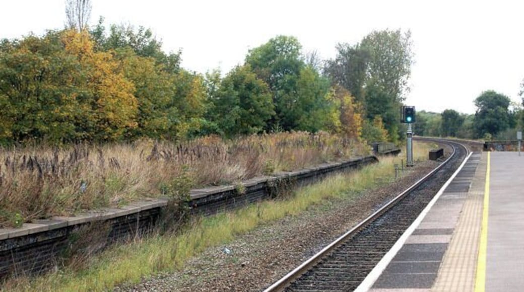 Olton railway station photo-survey (12) Looking in the down (northbound) direction at Olton station. Note the overgrown disused platform to the left of the photo (see below). Olton station is on the ex-GWR (Great western Railway) London to Birmingham line. It serves the suburbs of Olton and Ulverley Green about six miles east-southeast of Birmingham city centre. The line was originally built with double track and Olton station had two facing platforms, one either side of the two through lines. However, in the early 1930s the GWR quadrupled the track in the Birmingham area to cope with greatly increased suburban traffic. After quadrupling, Olton station had two island platforms, one serving the two down lines, the other serving the two up lines. Today, the route is reduced to two tracks again and one of Olton's 1930s island platforms (the one on the east side of the site) serves the up and down lines. The other island platform is no longer accessible and is very overgrown. Olton station is operated by London Midland as part of Network West Midlands and is a designated rail/bus interchange point. The majority of train services are operated by London midland but some Chiltern Railways trains call at Olton.