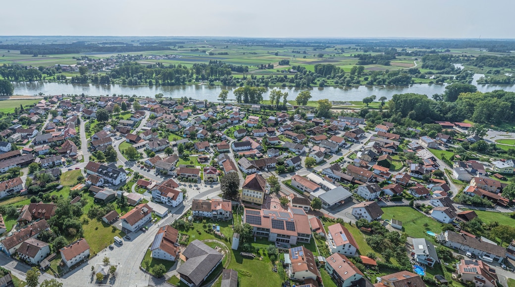 A residential area with houses, roads, and a river.