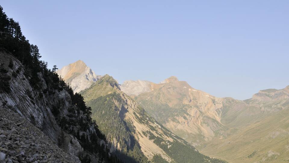 A mountainous landscape with rocky terrain and dense forests.