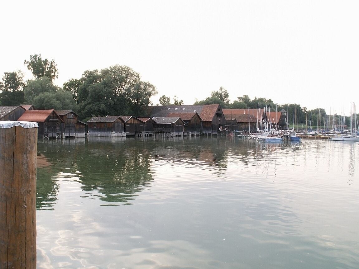 A waterfront with wooden buildings and boats.
