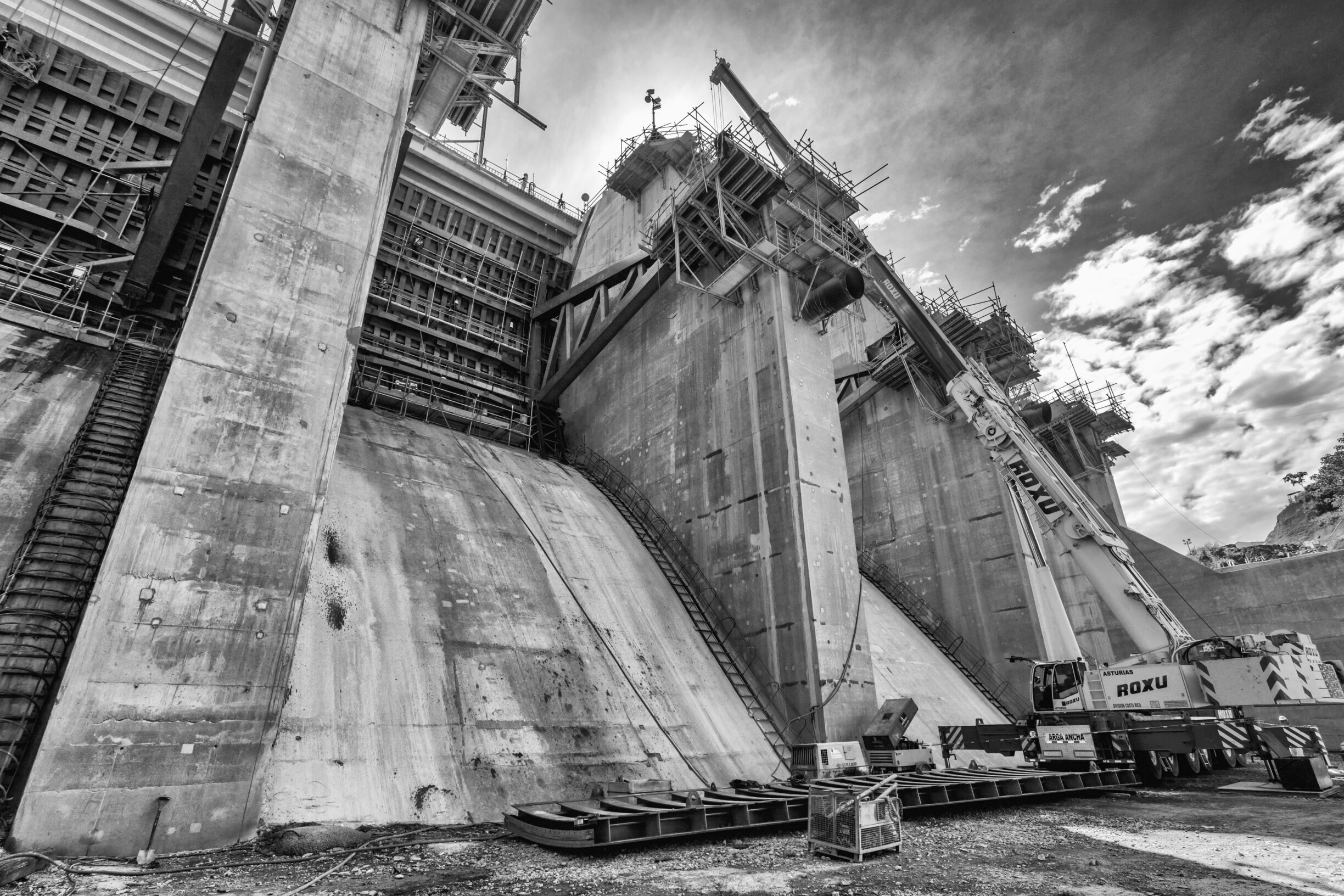 A large industrial structure with scaffolding and a crane, likely a construction site.